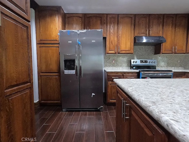 28132 Via Congora, Mission Viejo, CA 92692 - kitchen with brown cabinetry, appliances with stainless steel finishes, dark wood finished floors, light countertops, and under cabinet range hood