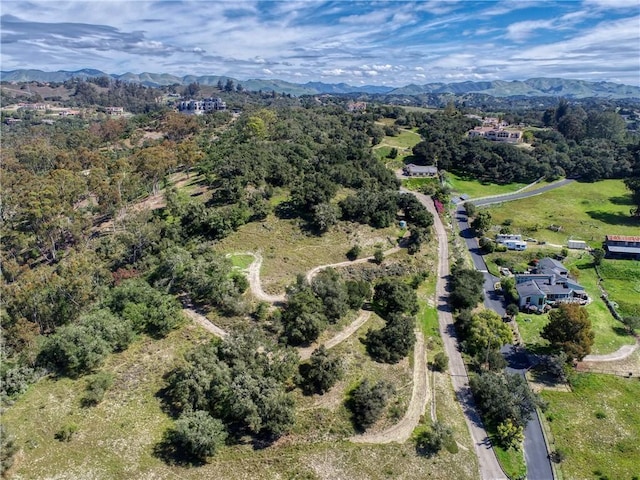aerial view with a mountain view and a view of trees