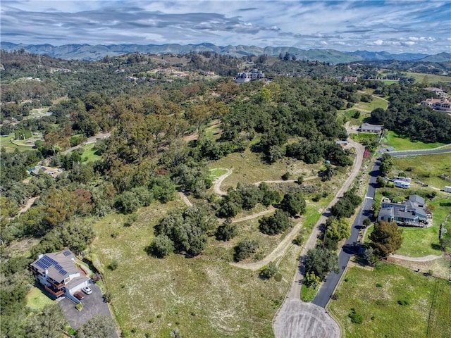 bird's eye view with a mountain view and a view of trees