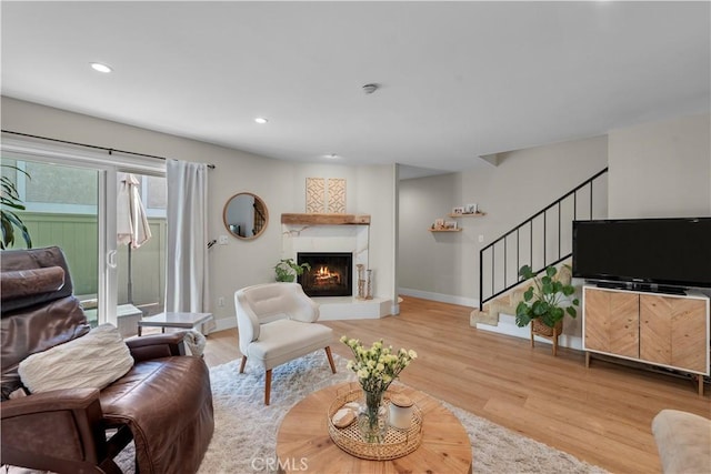 2204 Vanderbilt Ln Unit 16, Redondo Beach, CA 90278 - living room with stairway, recessed lighting, a warm lit fireplace, and wood finished floors