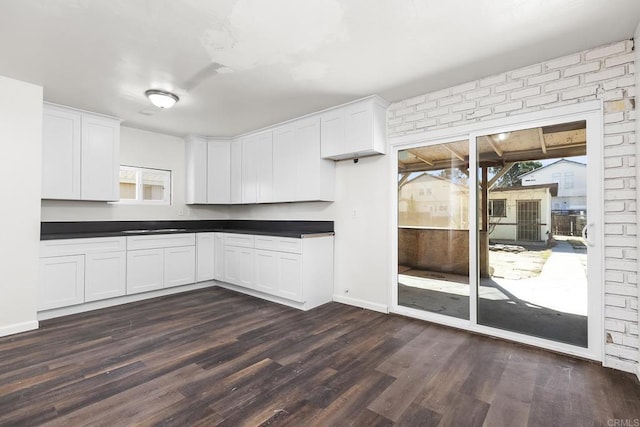 kitchen with plenty of natural light, dark countertops, and dark wood-style floors
