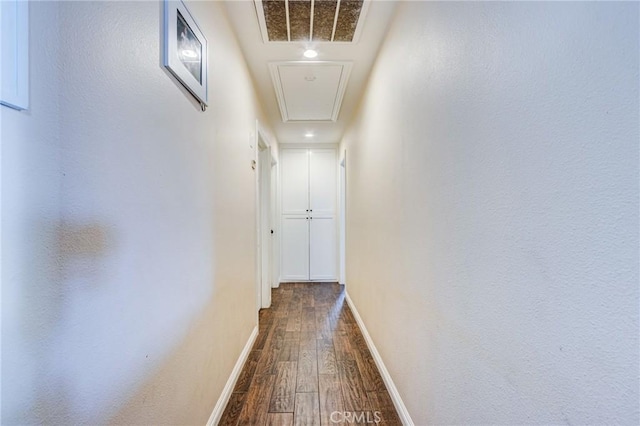 27485 Pachea Trl, Hemet, CA 92544 - corridor with attic access, visible vents, baseboards, and dark wood-style flooring