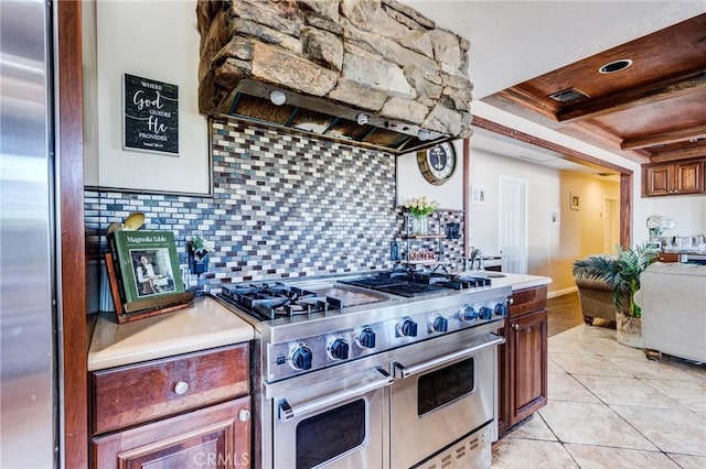 27485 Pachea Trl, Hemet, CA 92544 - kitchen featuring exhaust hood, light countertops, a tray ceiling, decorative backsplash, and appliances with stainless steel finishes