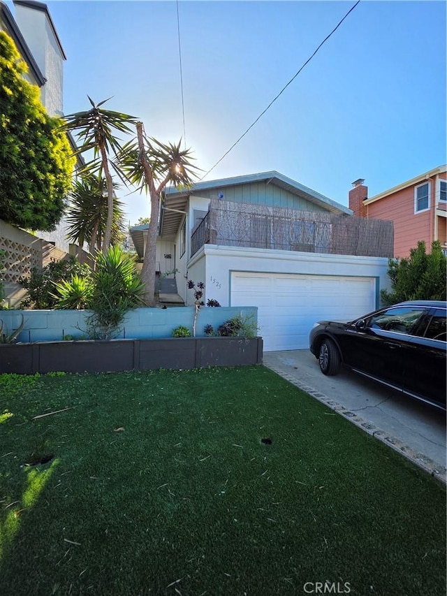 view of property exterior featuring concrete driveway, a lawn, and a garage