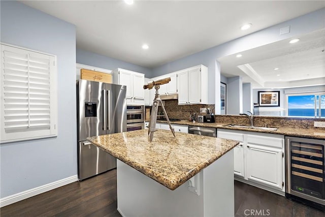 21732 Wesley Dr Unit 6, Laguna Beach, CA 92651 - kitchen featuring stainless steel appliances, wine cooler, a sink, light stone counters, and dark wood finished floors