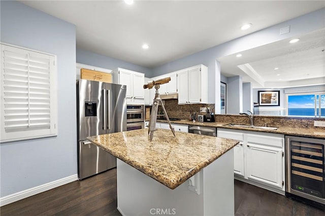 21732 Wesley Dr Unit 6, Laguna Beach, CA 92651 - kitchen with wine cooler, light stone counters, appliances with stainless steel finishes, dark wood-style flooring, and recessed lighting