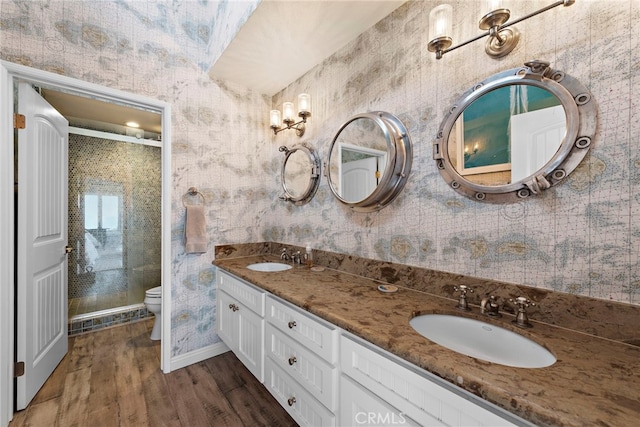 21732 Wesley Dr Unit 6, Laguna Beach, CA 92651 - bathroom with toilet, wood finished floors, a stall shower, double vanity, and wallpapered walls