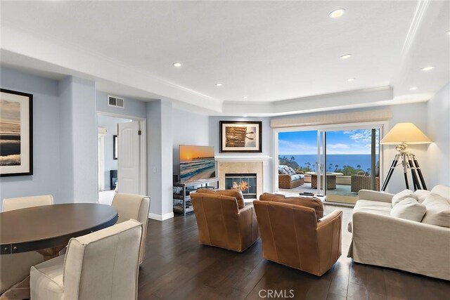 21732 Wesley Dr Unit 6, Laguna Beach, CA 92651 - living room featuring dark wood-type flooring, a tray ceiling, a glass covered fireplace, baseboards, and recessed lighting