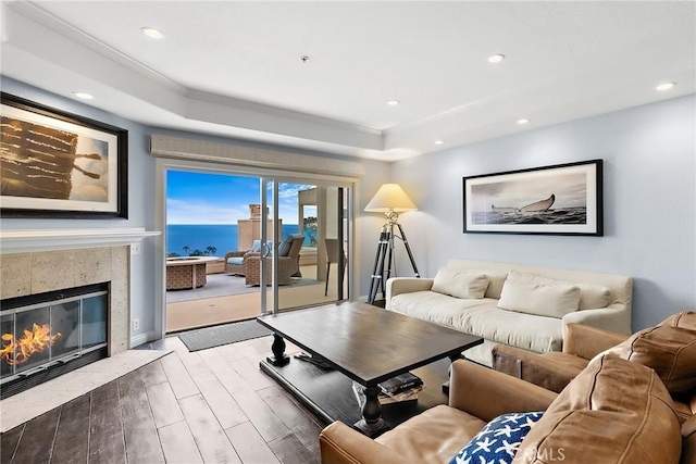 21732 Wesley Dr Unit 6, Laguna Beach, CA 92651 - living room featuring wood finished floors, recessed lighting, a raised ceiling, a tiled fireplace, and ornamental molding