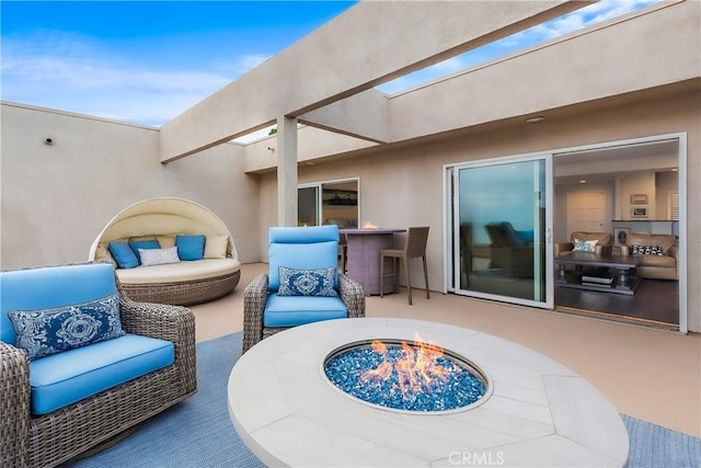 view of patio featuring outdoor dry bar and a fire pit
