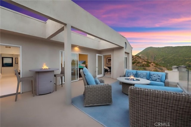 21732 Wesley Dr Unit 6, Laguna Beach, CA 92651 - patio terrace at dusk featuring a patio, a mountain view, and an outdoor living space with a fire pit