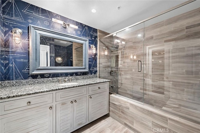 full bath with vanity and a shower stall
