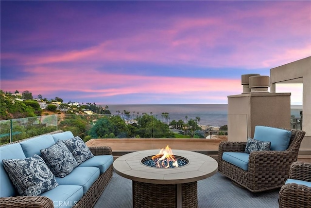 21732 Wesley Dr Unit 6, Laguna Beach, CA 92651 - patio terrace at dusk with an outdoor living space with a fire pit and a water view