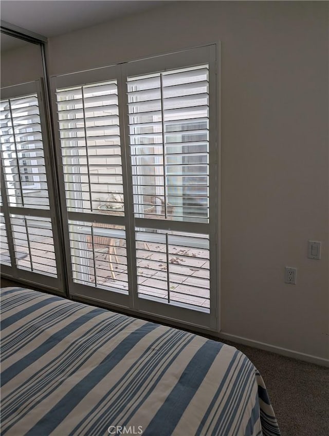 unfurnished bedroom with baseboards and carpet floors