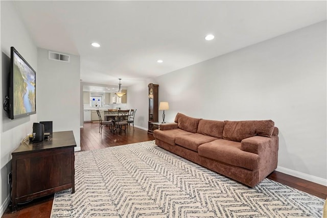 living area featuring dark wood finished floors, recessed lighting, visible vents, and baseboards