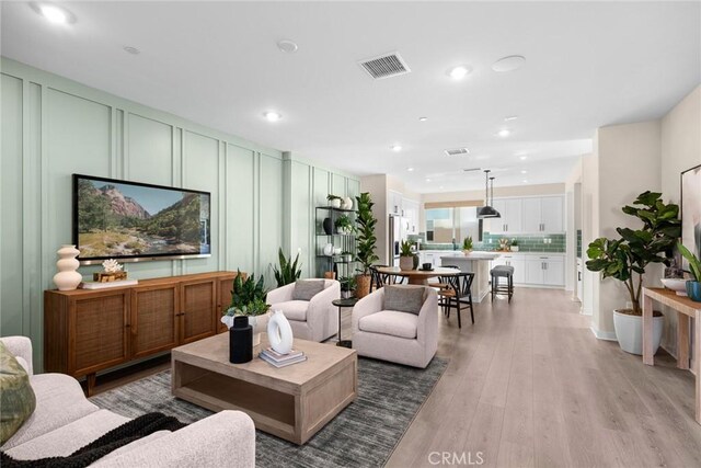 1810 E 1st St Unit 130, Santa Ana, CA 92705 - living room with a decorative wall, recessed lighting, and light wood-type flooring
