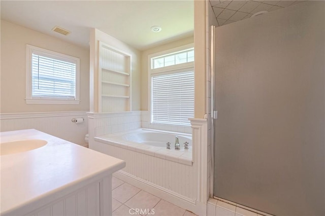 bathroom with tile patterned flooring, visible vents, a healthy amount of sunlight, and a shower stall