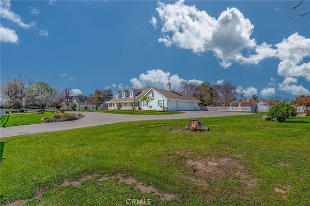 view of yard featuring driveway and a garage