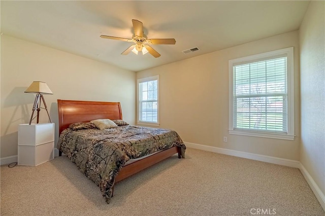 carpeted bedroom with visible vents, ceiling fan, and baseboards