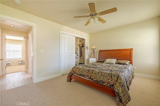 bedroom featuring a closet, carpet floors, baseboards, and a ceiling fan