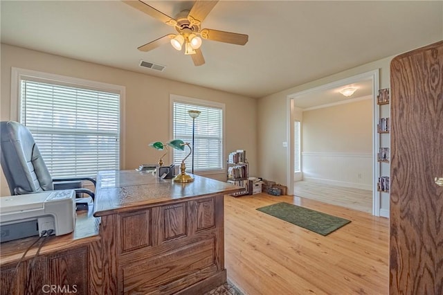 office space featuring visible vents, light wood-style flooring, and ceiling fan