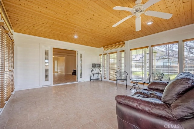 living room with baseboards, recessed lighting, wood ceiling, and ceiling fan