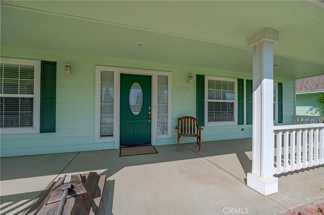 view of exterior entry featuring a porch