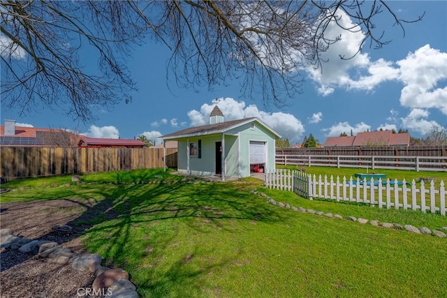 view of yard featuring an outdoor structure and a fenced backyard