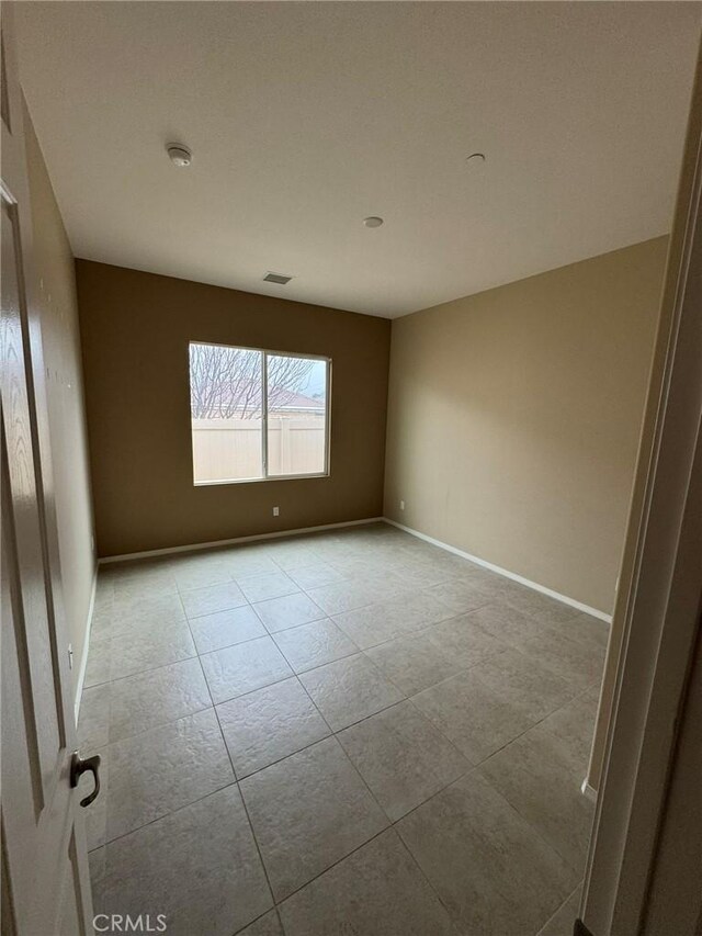 1572 Humboldt Peak, Beaumont, CA 92223 - spare room with light tile patterned flooring, a smoke detector, and baseboards