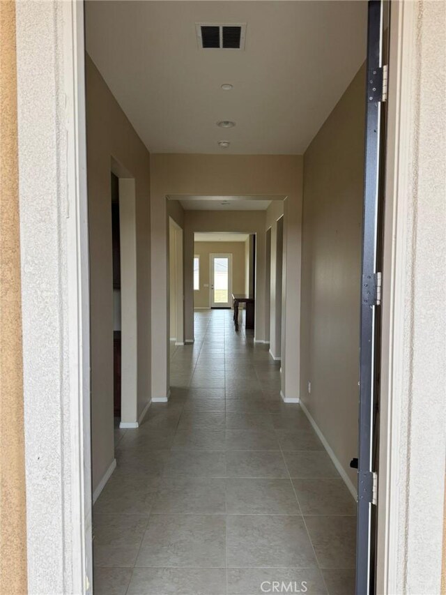 1572 Humboldt Peak, Beaumont, CA 92223 - corridor with baseboards and light tile patterned floors