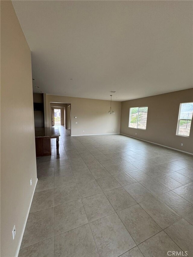 1572 Humboldt Peak, Beaumont, CA 92223 - unfurnished room with healthy amount of natural light, baseboards, and light tile patterned floors