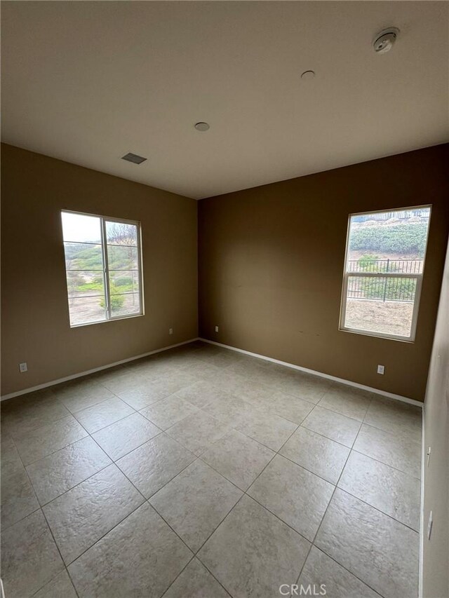1572 Humboldt Peak, Beaumont, CA 92223 - tiled empty room featuring a smoke detector and baseboards