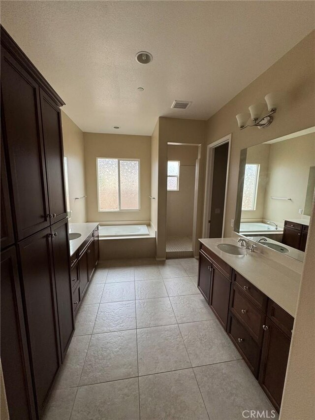 1572 Humboldt Peak, Beaumont, CA 92223 - full bath featuring a stall shower, a garden tub, vanity, tile patterned flooring, and a textured ceiling