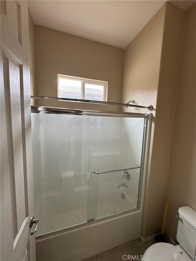 1572 Humboldt Peak, Beaumont, CA 92223 - bathroom featuring toilet, shower / bath combination with glass door, and tile patterned flooring