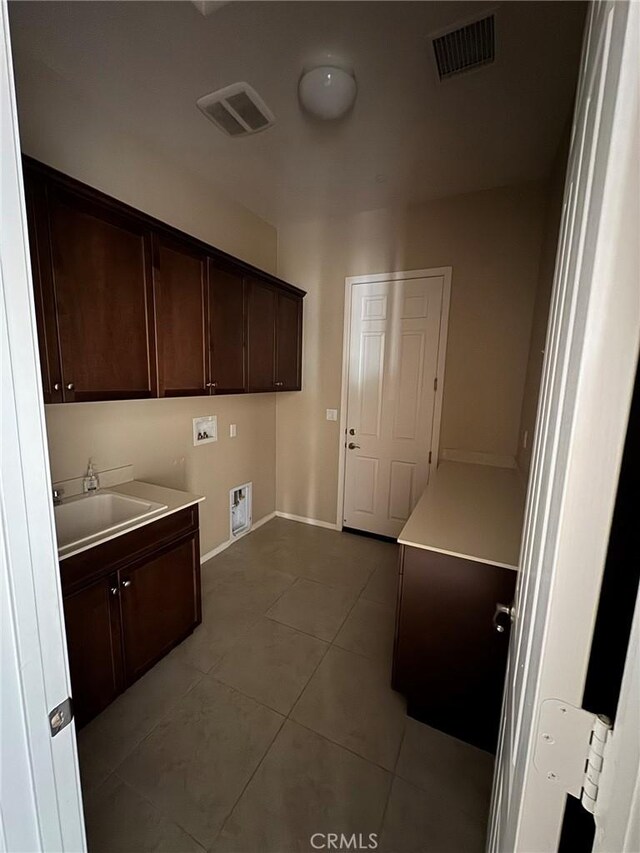 1572 Humboldt Peak, Beaumont, CA 92223 - laundry area featuring cabinet space, tile patterned flooring, washer hookup, and baseboards