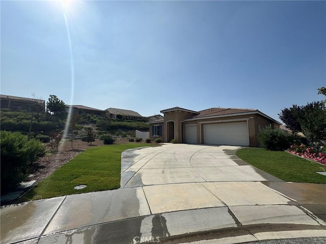 1572 Humboldt Peak, Beaumont, CA 92223 - view of front of property with driveway, an attached garage, a front lawn, stucco siding, and a tile roof