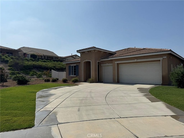 1572 Humboldt Peak, Beaumont, CA 92223 - mediterranean / spanish-style house featuring stucco siding, a tiled roof, an attached garage, driveway, and a front lawn