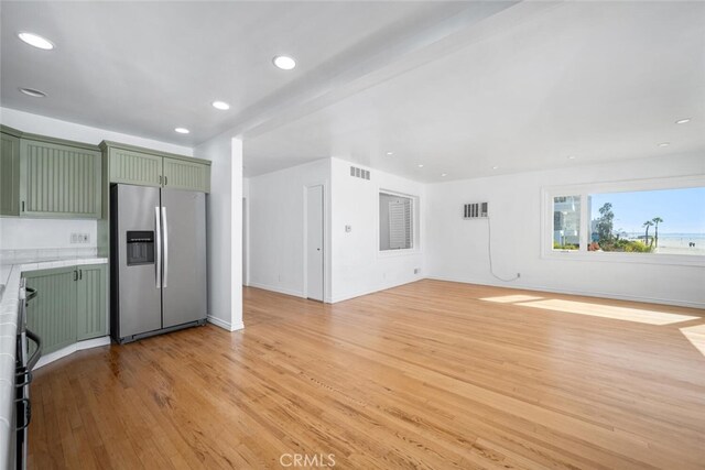 unfurnished living room with visible vents, recessed lighting, light wood finished floors, and baseboards