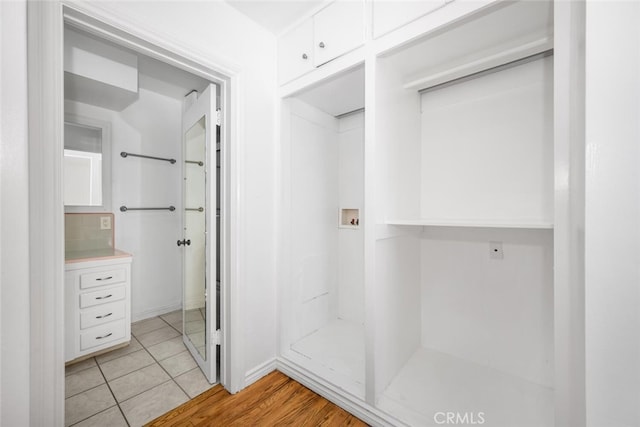 bathroom with baseboards and tile patterned flooring
