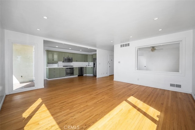 unfurnished living room with visible vents, recessed lighting, and light wood finished floors