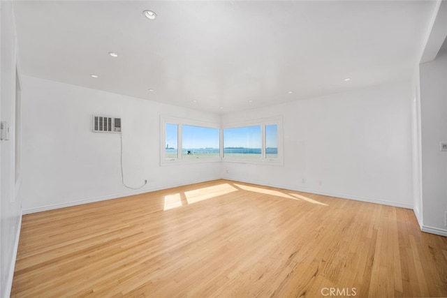 unfurnished room featuring recessed lighting, baseboards, visible vents, and light wood finished floors
