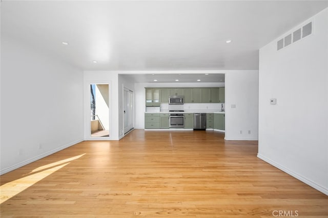 unfurnished living room with recessed lighting, baseboards, and visible vents
