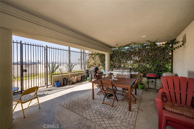 view of patio / terrace with fence, grilling area, and outdoor dining space