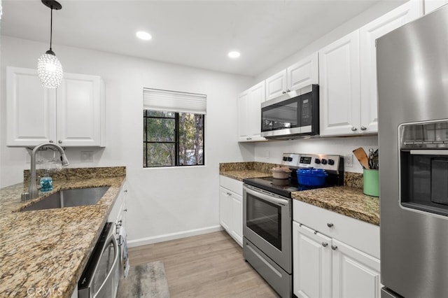 32221 Alipaz St Unit 266, San Juan Capistrano, CA 92675 - kitchen featuring appliances with stainless steel finishes, a sink, light wood-type flooring, baseboards, and white cabinets