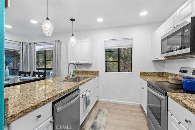 32221 Alipaz St Unit 266, San Juan Capistrano, CA 92675 - kitchen with appliances with stainless steel finishes, a sink, light wood-type flooring, baseboards, and white cabinets