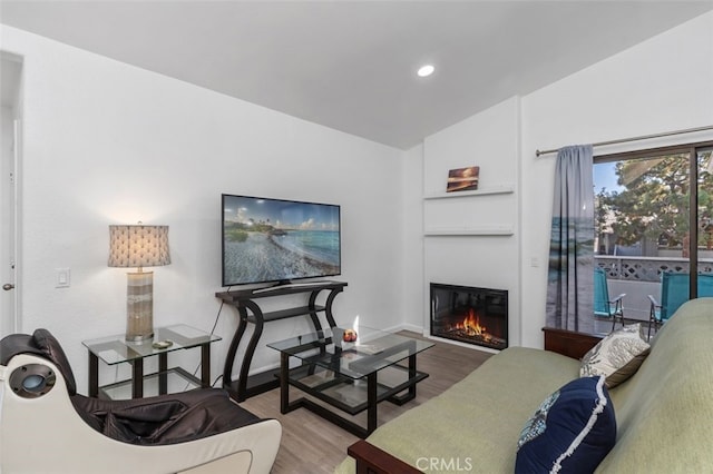 32221 Alipaz St Unit 266, San Juan Capistrano, CA 92675 - living room with wood finished floors, a glass covered fireplace, vaulted ceiling, baseboards, and recessed lighting