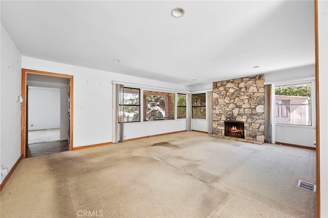 unfurnished living room featuring visible vents, a fireplace, and carpet floors