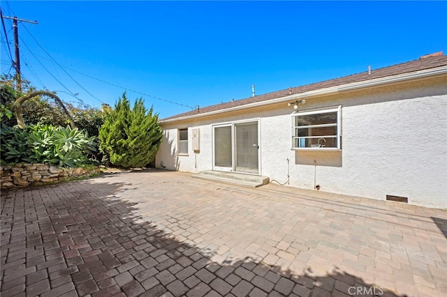 back of house featuring a patio area and stucco siding