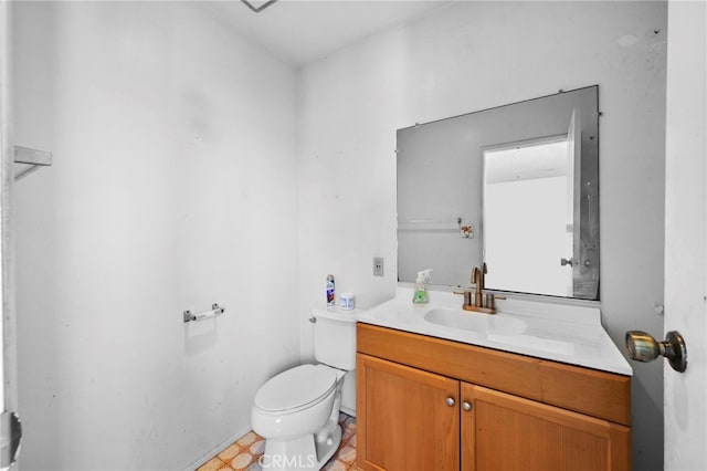 bathroom featuring toilet and vanity