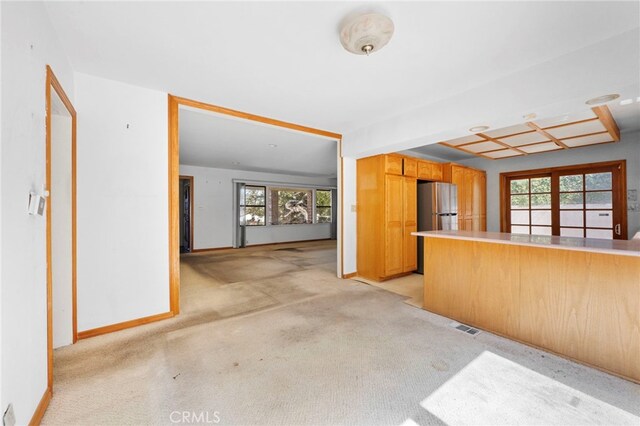 kitchen featuring visible vents, plenty of natural light, and light colored carpet